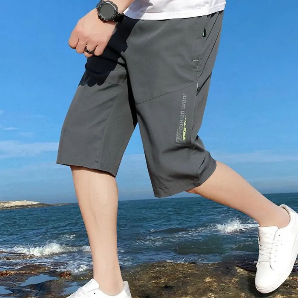 Men Cropped Pants Elastic Waist Loose Ice Silk Casual Pants Zipper Pockets Solid Color Mid Waist Men Mid-calf Length Trousers