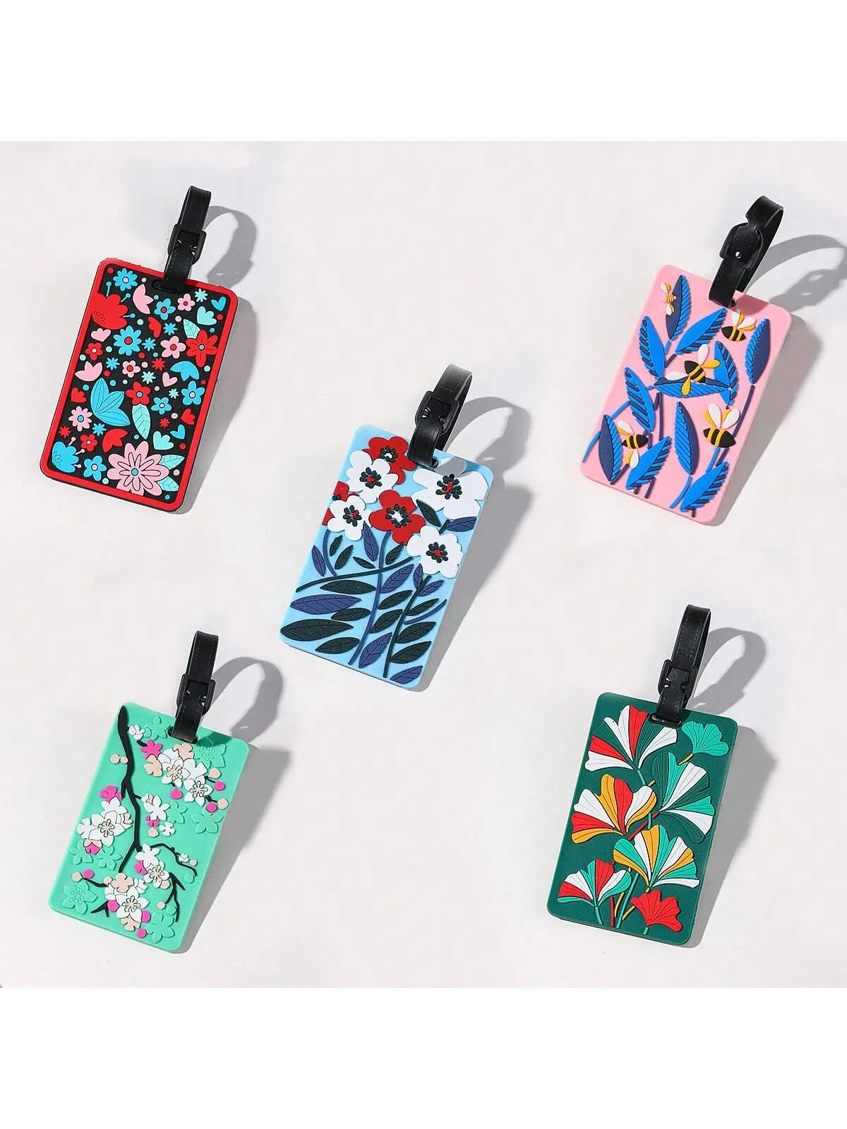 Luggage tags with floral patterns, aircraft boarding passes with colored luggage identifiers, and travel identification tagsA-DH