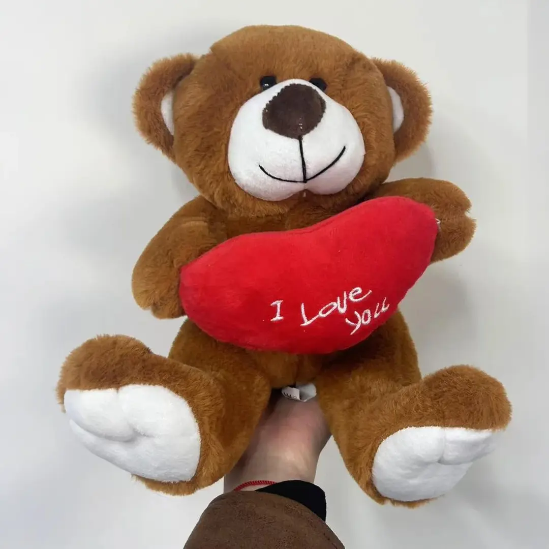 A lovely teddy bear holding a heart, a teddy bear doll, a cute heart-holding bear, suitable as a Valentine's Day gift.