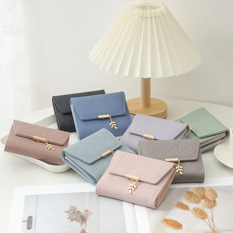 Autumn and winter new women's short wallet Japan and South Korea small fresh PU simple folding hardware leaf pendant three fold