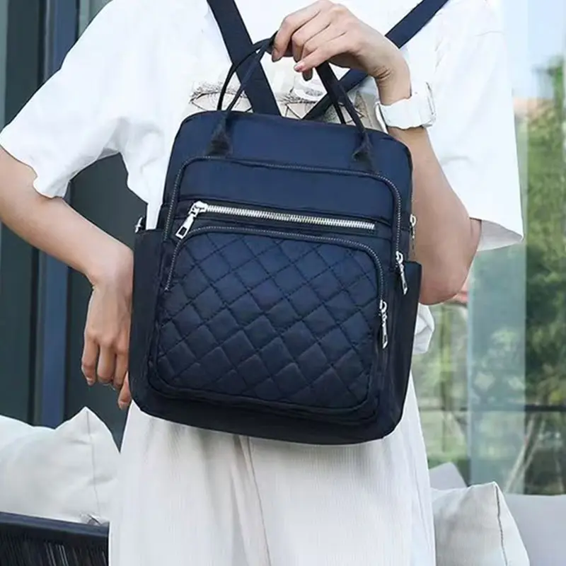 Neutral color backpack for men and women, with dual shoulder straps, can be carried by hand, suitable for school and travel.