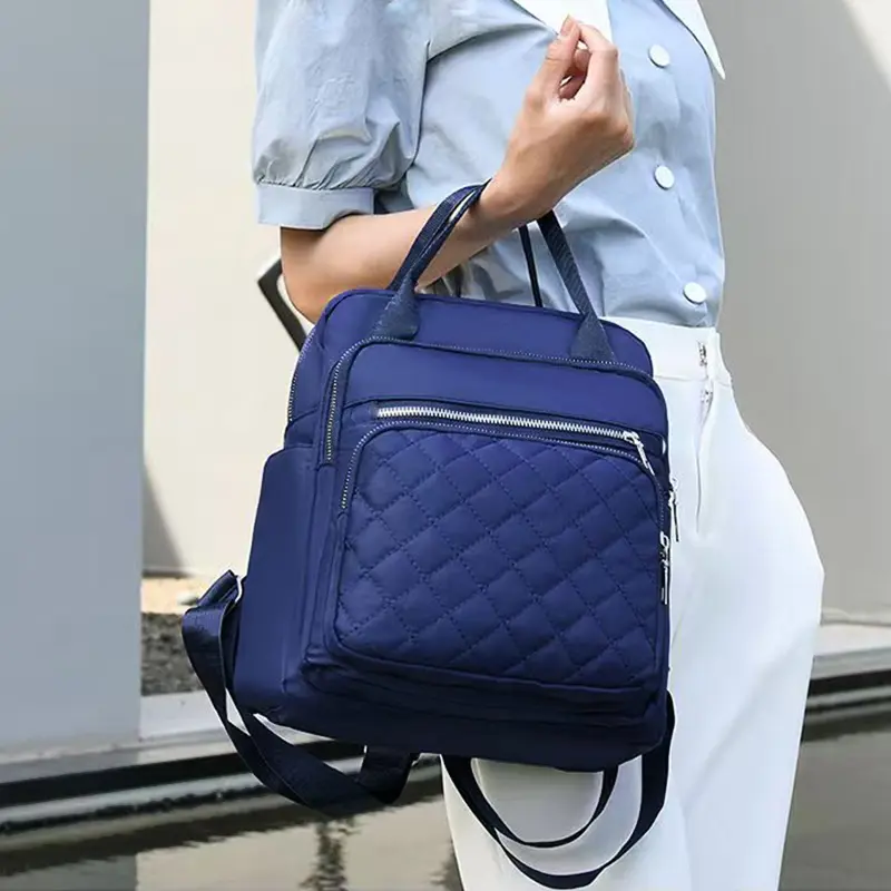 Neutral color backpack for men and women, with dual shoulder straps, can be carried by hand, suitable for school and travel.