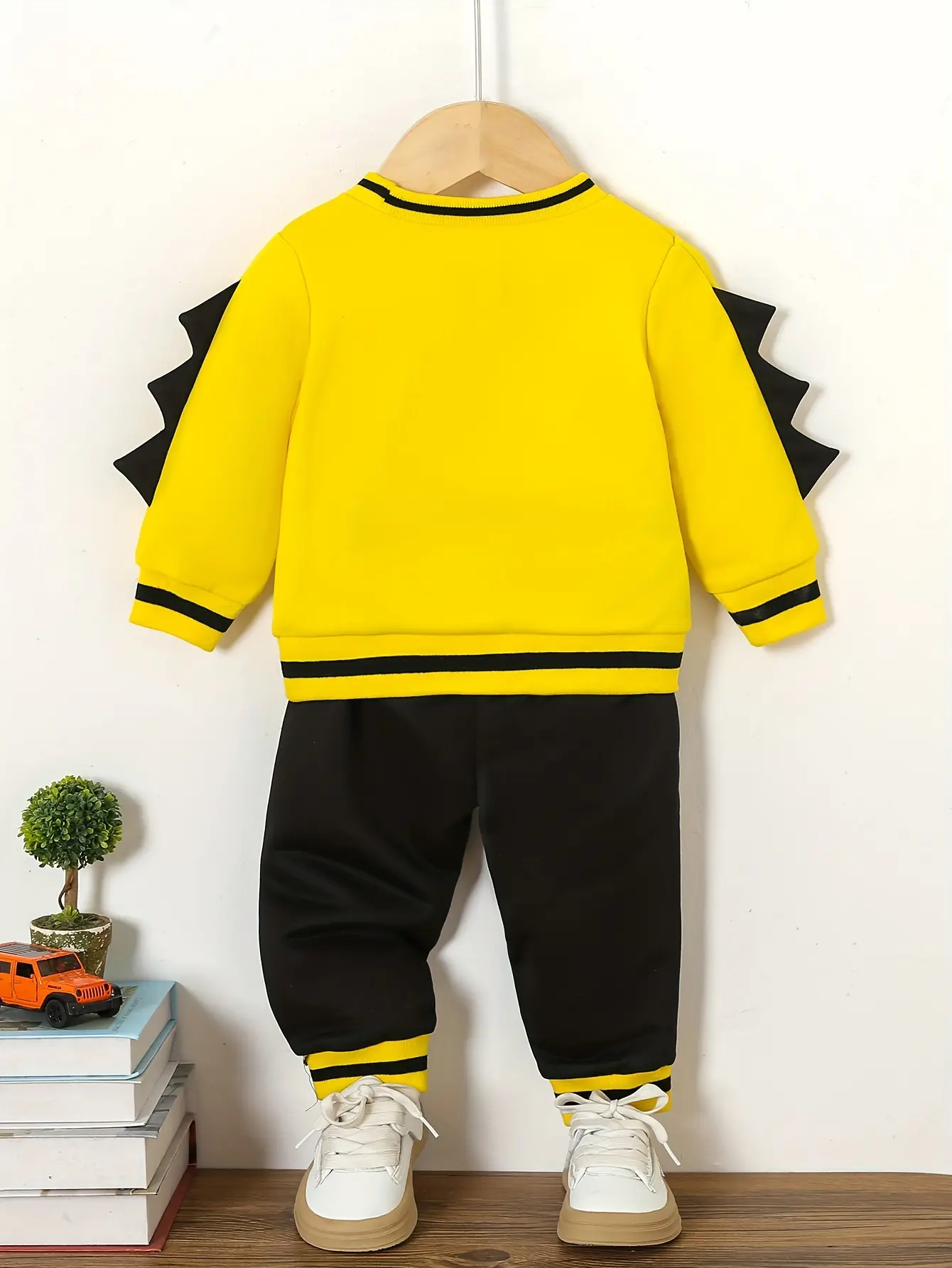 A Baby Boy's Autumn And Winter Casual Hoodie Set Features A Cute Expression Printed Color-Blocking Top And Sporty Trousers