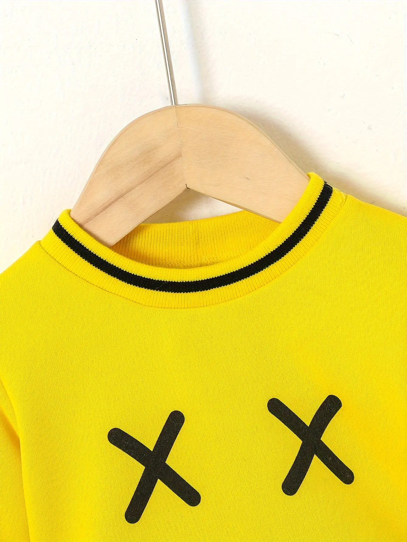 A Baby Boy's Autumn And Winter Casual Hoodie Set Features A Cute Expression Printed Color-Blocking Top And Sporty Trousers