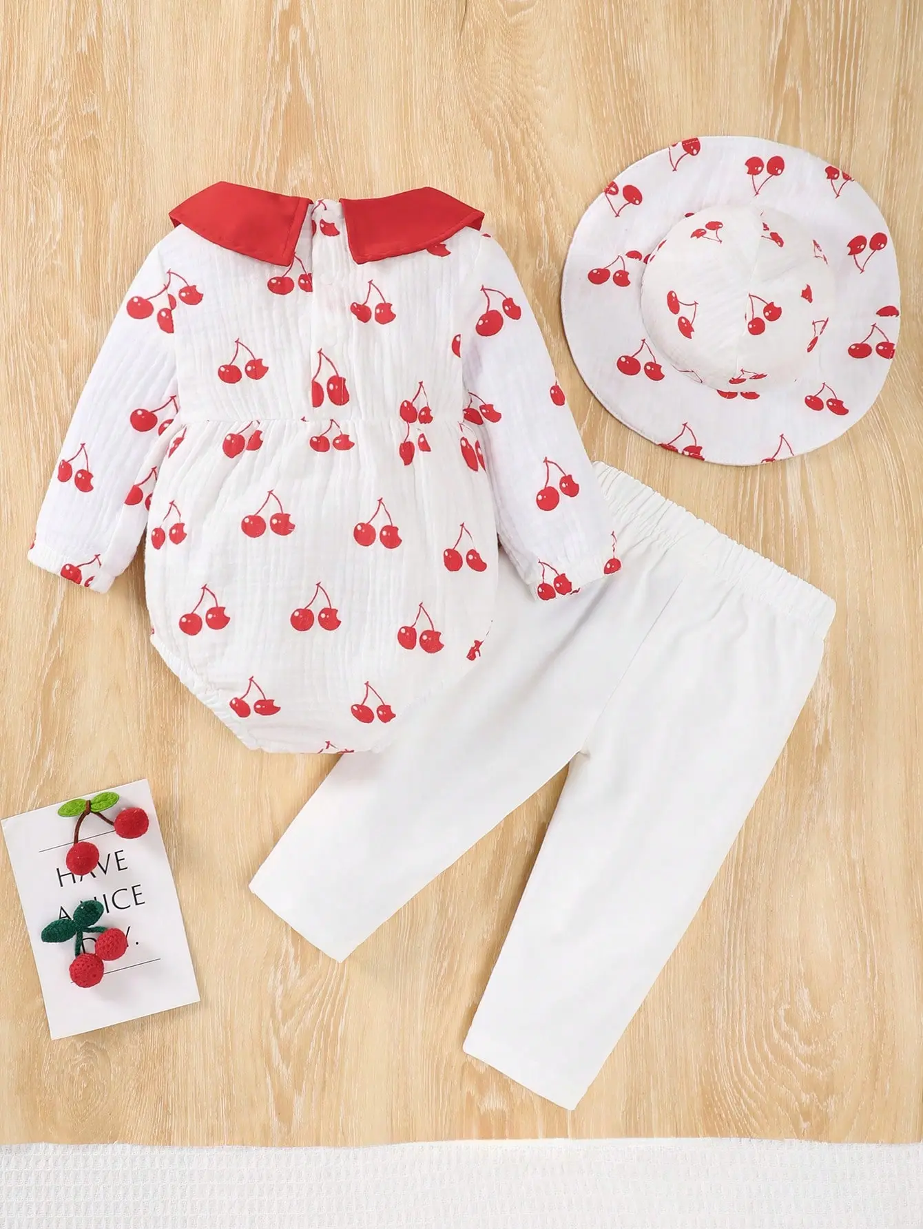 A 3-Piece Set Of Cherry Print Long-Sleeved Climbing Triangle Pants Long Pants And A Hat For Newborns In Spring And Autumn