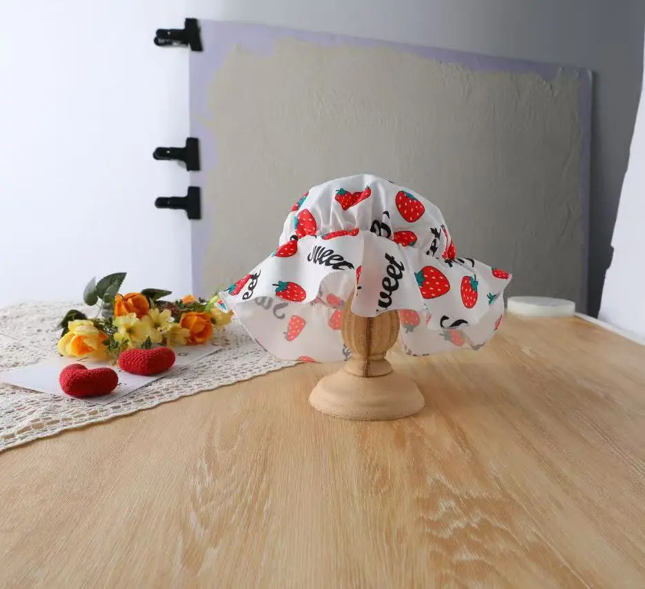 A Fashionable Summer Strawberry-Printed Off-Shoulder Crop Top, Mini Skirt, and Hat Set in a Sweet and Cute Style