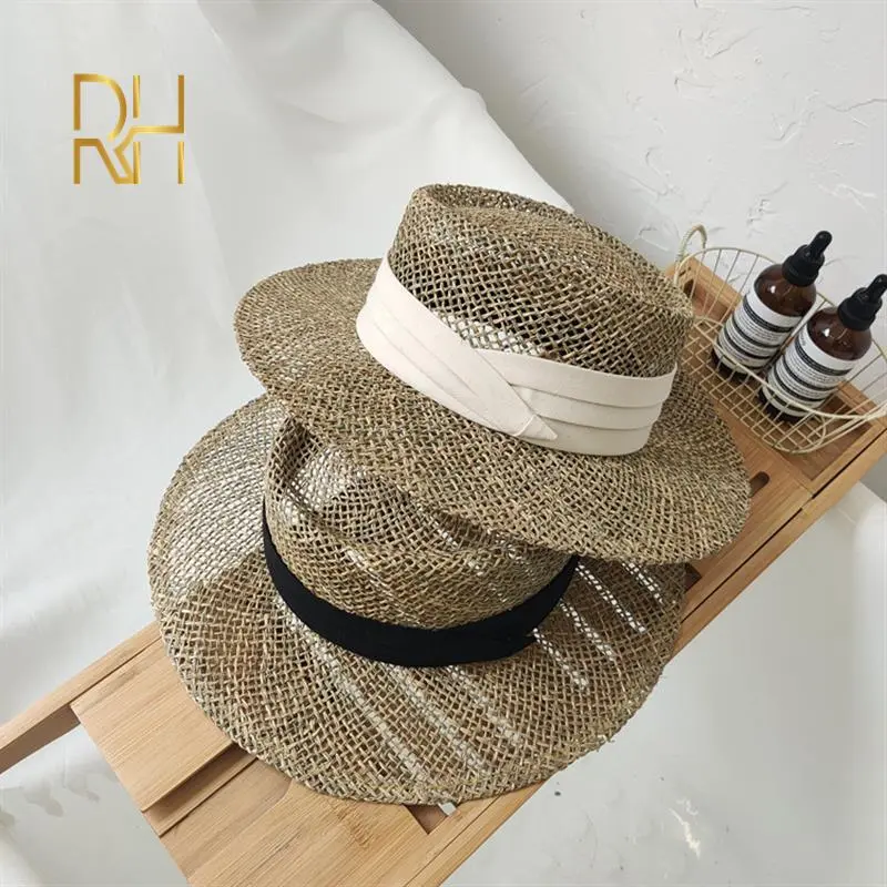 Travel Natural seagrass hollow flat brim hat ladies summer porkpie concave round sun hat beach straw hat with ribbon wholesale