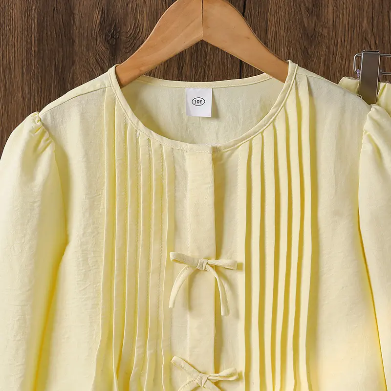 Big child's sweet two-piecesSpring/summer yellow bow detailPuffed sleevesRounded necklineFrilled hemLong-sleeved topYellow strai