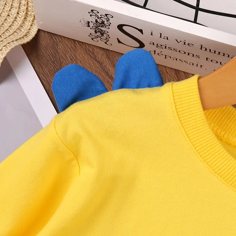 Unisex Playful Cartoon Little Dino Yellow Long Sleeve T-Shirt Spring-Fall Casual Cute Base Layer Top for Everyday Wear