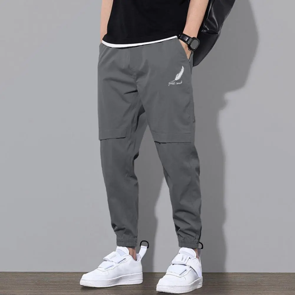 Trendy Logo Print Men Pants Mid-Rise Elastic Waistband Pockets Men Pants Solid Color Loose Fit Sweatpants Casual Streetwear