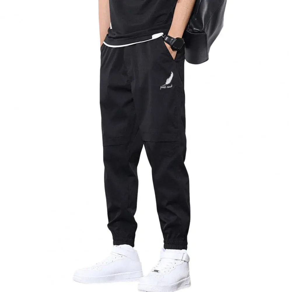 Trendy Logo Print Men Pants Mid-Rise Elastic Waistband Pockets Men Pants Solid Color Loose Fit Sweatpants Casual Streetwear